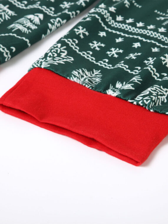 Modern green Christmas pyjamas with winter motifs, snowflakes, fir trees