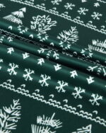 Modern green Christmas pyjamas with winter motifs, snowflakes, fir trees