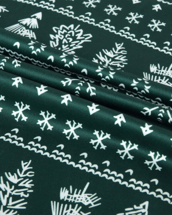 Modern green Christmas pajamas with winter motifs, snowflakes, fir trees