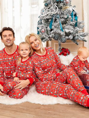 Christmas pyjamas winter modern patterns red family sitting in front of a fir tree