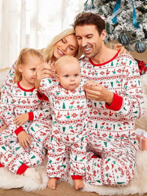 White winter pyjamas with modern patterns family sitting in front of the tree